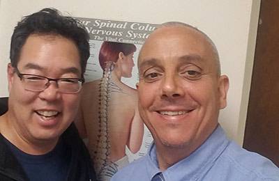 Chiropractor Flushing NY Michael Rogers with Happy Patient